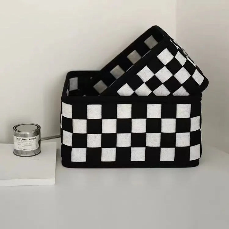 Checkerboard patterned foldable felt storage basket showing its box shape and textured sides.