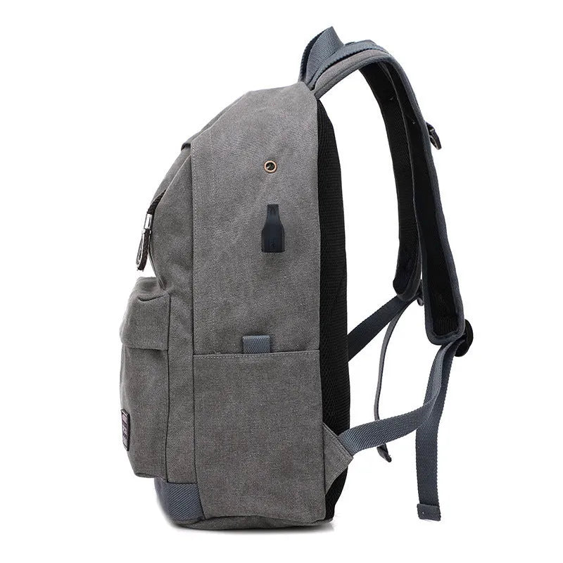 Canvas USB charging backpack in grey colour showing front pockets and shoulder straps