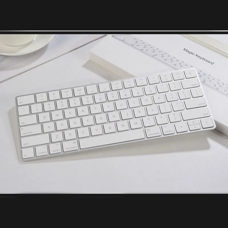 White Apple G6 ultra-thin metal Bluetooth wireless keyboard on a desk.