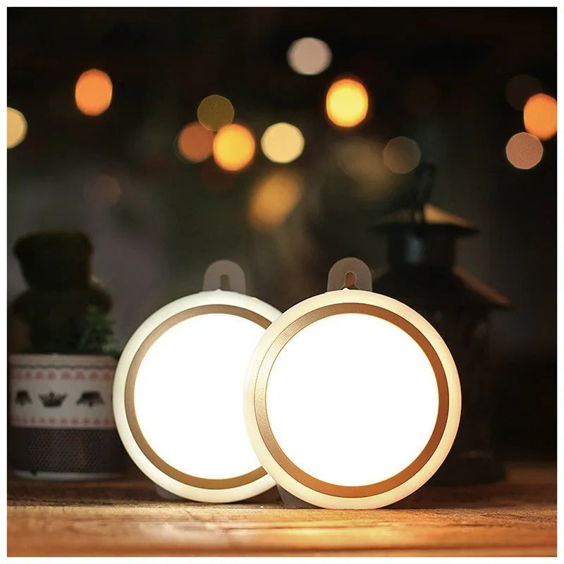 Round white motion sensor LED light unit with PIR sensor and LED array.