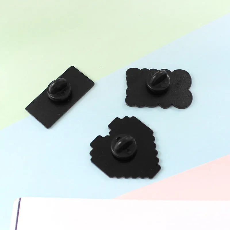 Alloy game console badge with magnetic backing in CC1122, CC1123, and CC1124 colour options
