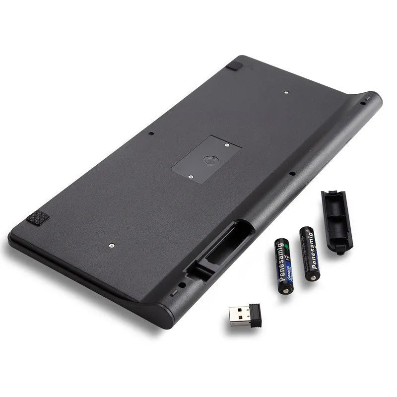 Black and white wireless keyboard and mouse set with USB receiver on wooden desk