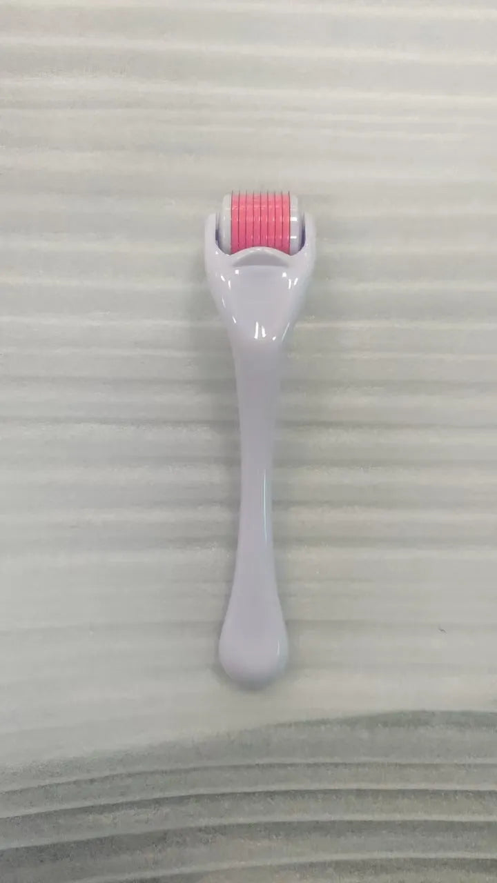 Sterile 540 micro needle derma roller showing handle and needle wheel in assorted colours.