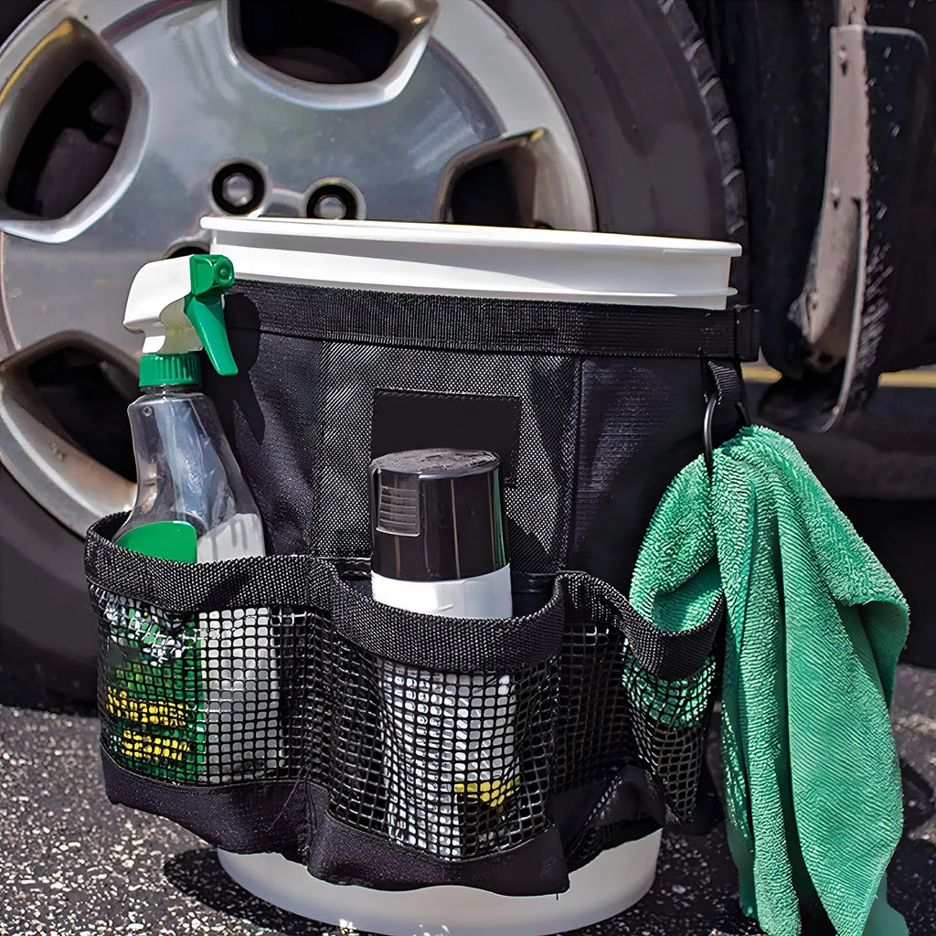 Black cylindrical polyester storage bag hanging on a 5 gallon barrel with car washing tools inside