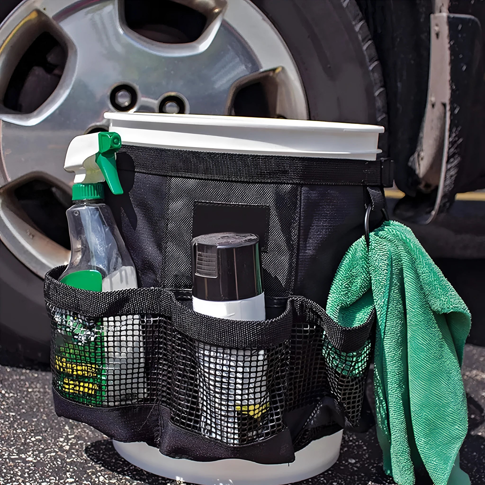 Black cylindrical polyester storage bag hanging on a 5 gallon barrel with car washing tools inside