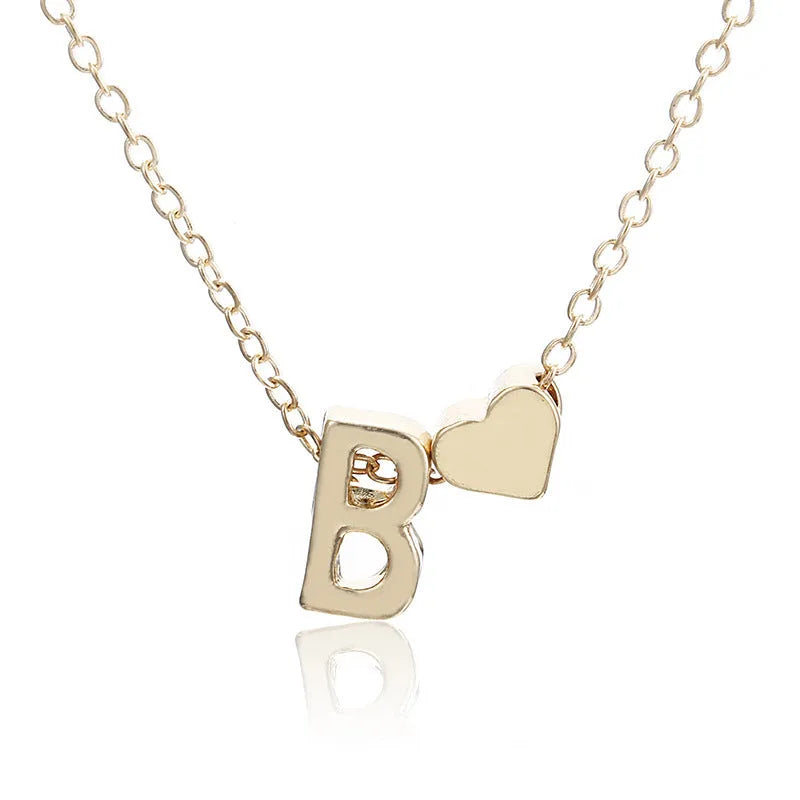 Peach heart shaped letter necklace pendant in gold and silver alloy tones weighing 5.5g