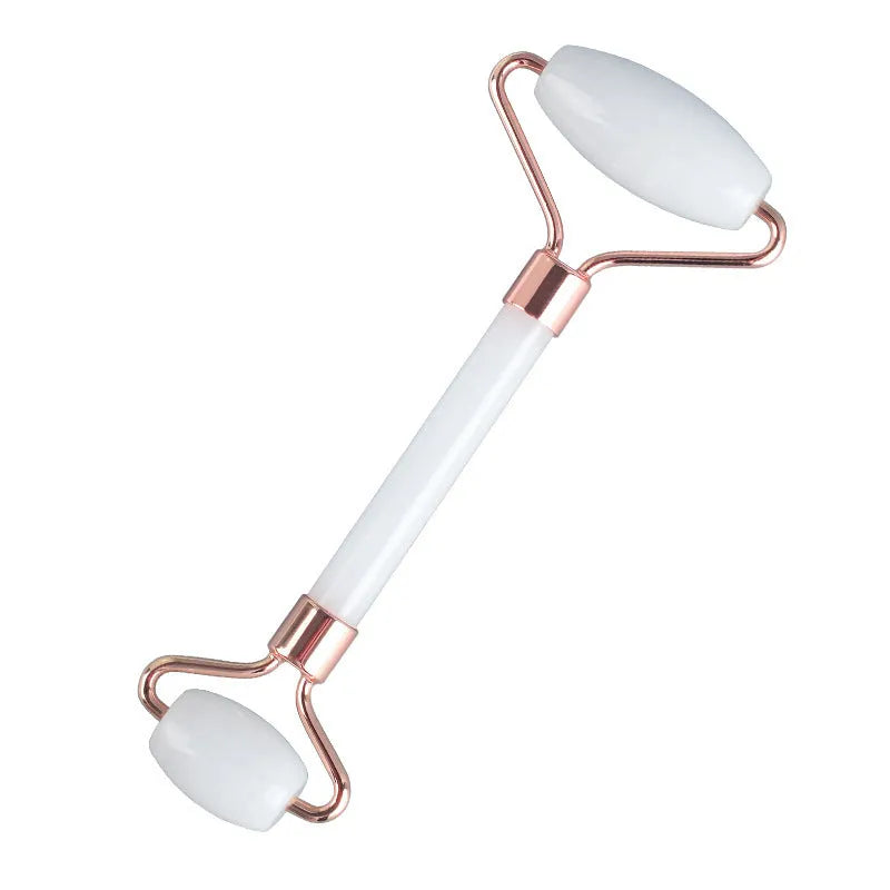Natural white jade roller and gua sha scraping tool set presented on a wooden storage board.