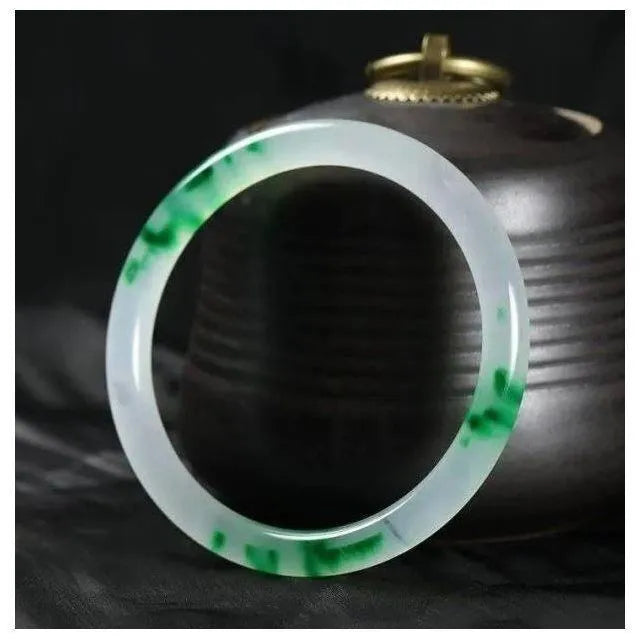 Jade bracelet with floating flower design and auspicious cloud patterns in green colour variation