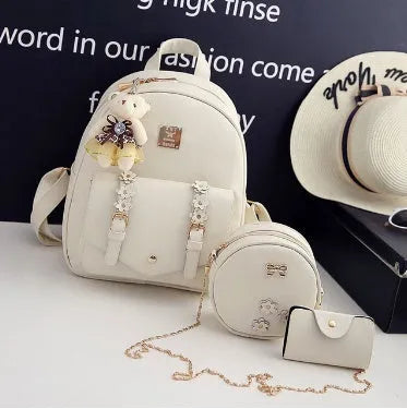 Women's three-piece leather backpack set with floral design showing backpack, shoulder bag, and card holder