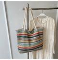 Blue woven nylon shoulder bag with adjustable strap showing straw-like texture pattern