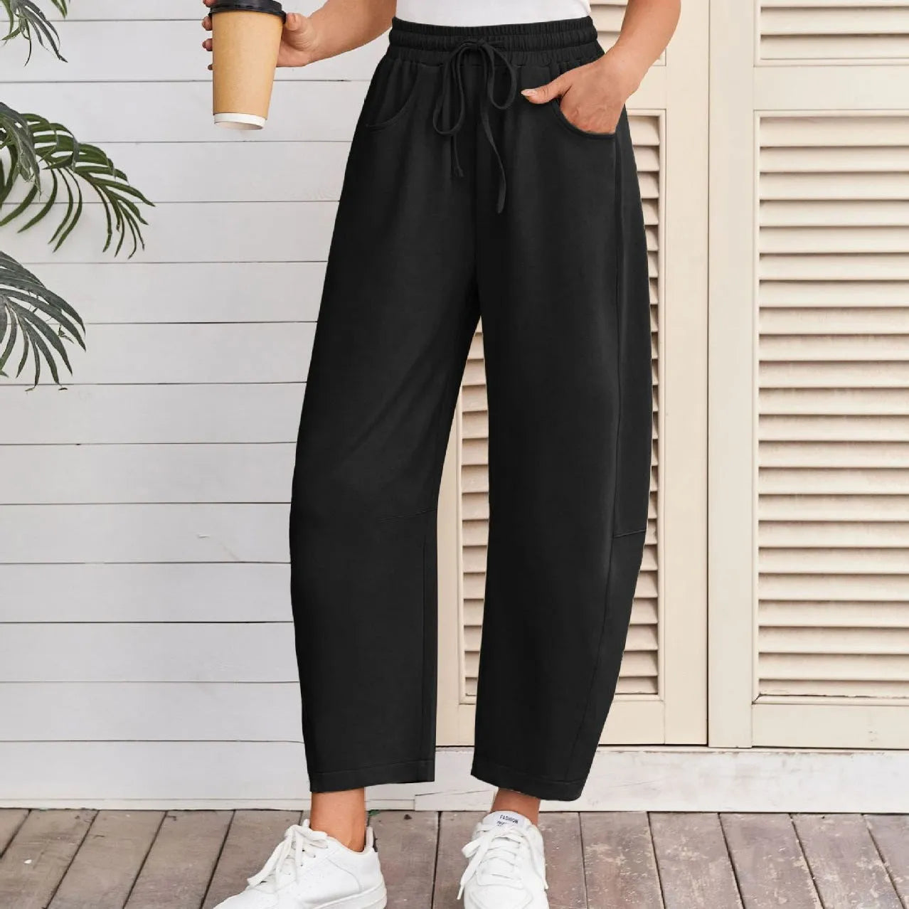 Women's loose cropped sweatpants with drawstring waist and side pockets in street fashion style