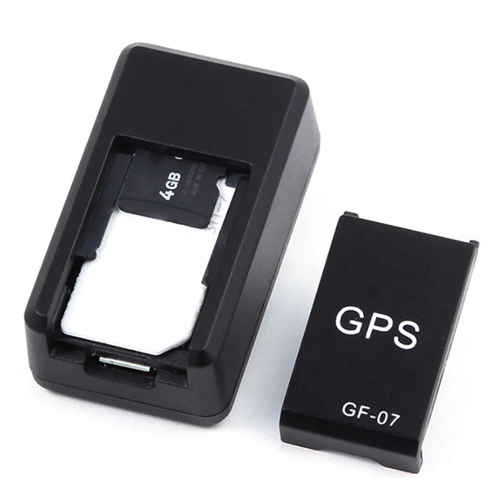 Small black magnetic GPS car tracker device with USB charging cable.