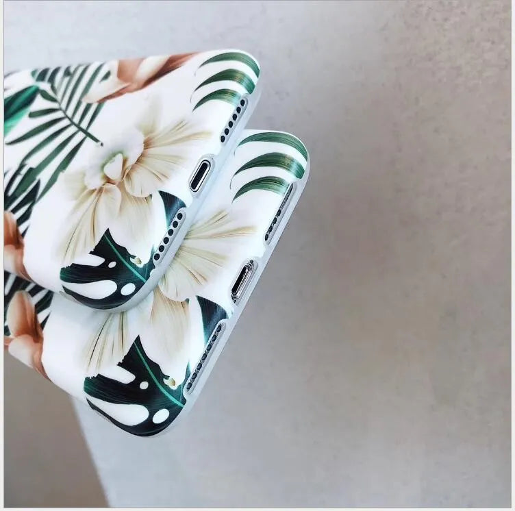 Soft TPU iPhone case with green banana leaf and pink floral art design on a white background.