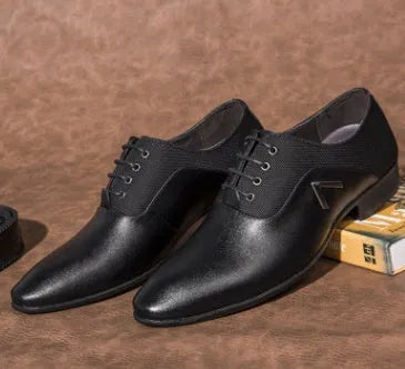 Men's black Oxford shoes with a rubber sole on a white background.