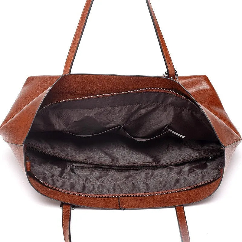 Brown wax cowhide cross-body leather handbag with two compartments showing internal mobile phone pouch.