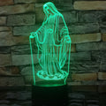 3D LED night light showing colourful dual ring pattern on acrylic panel, with remote control on desk.