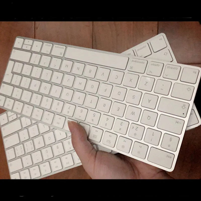 White Apple G6 ultra-thin metal Bluetooth wireless keyboard on a desk.