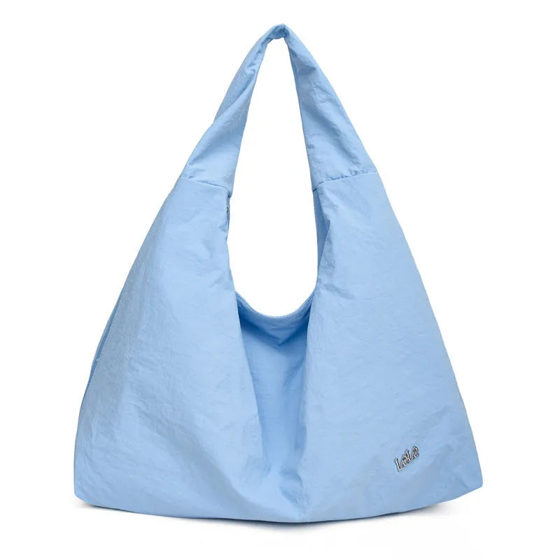 Soft nylon women's underarm bag in a heart shape, shown in black, blue, khaki, and yellow colours.