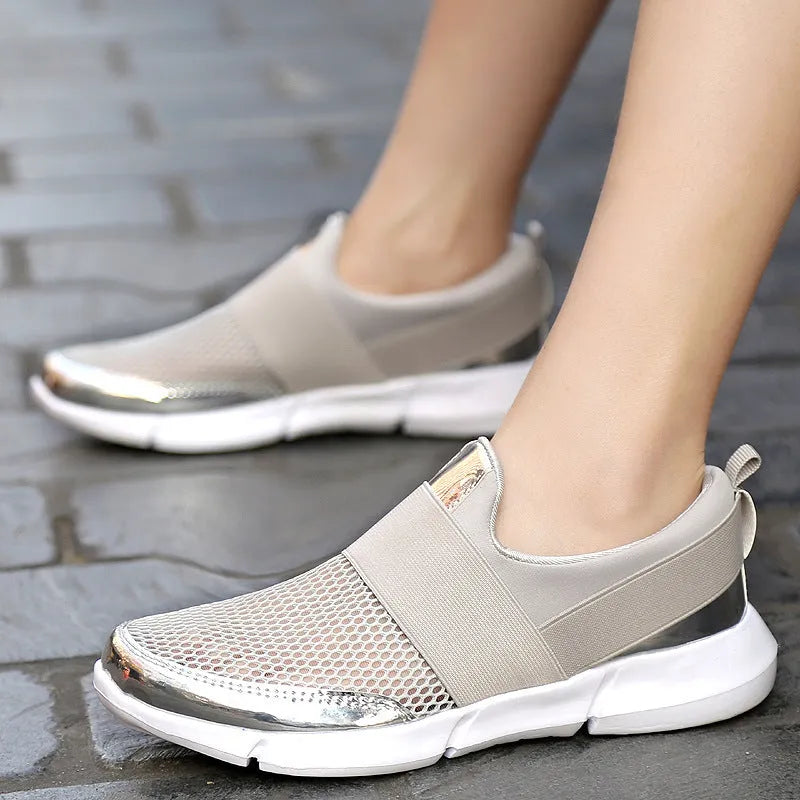 Women's lightweight sneakers with mesh interior in blue, black, and grey colours showing low-cut design