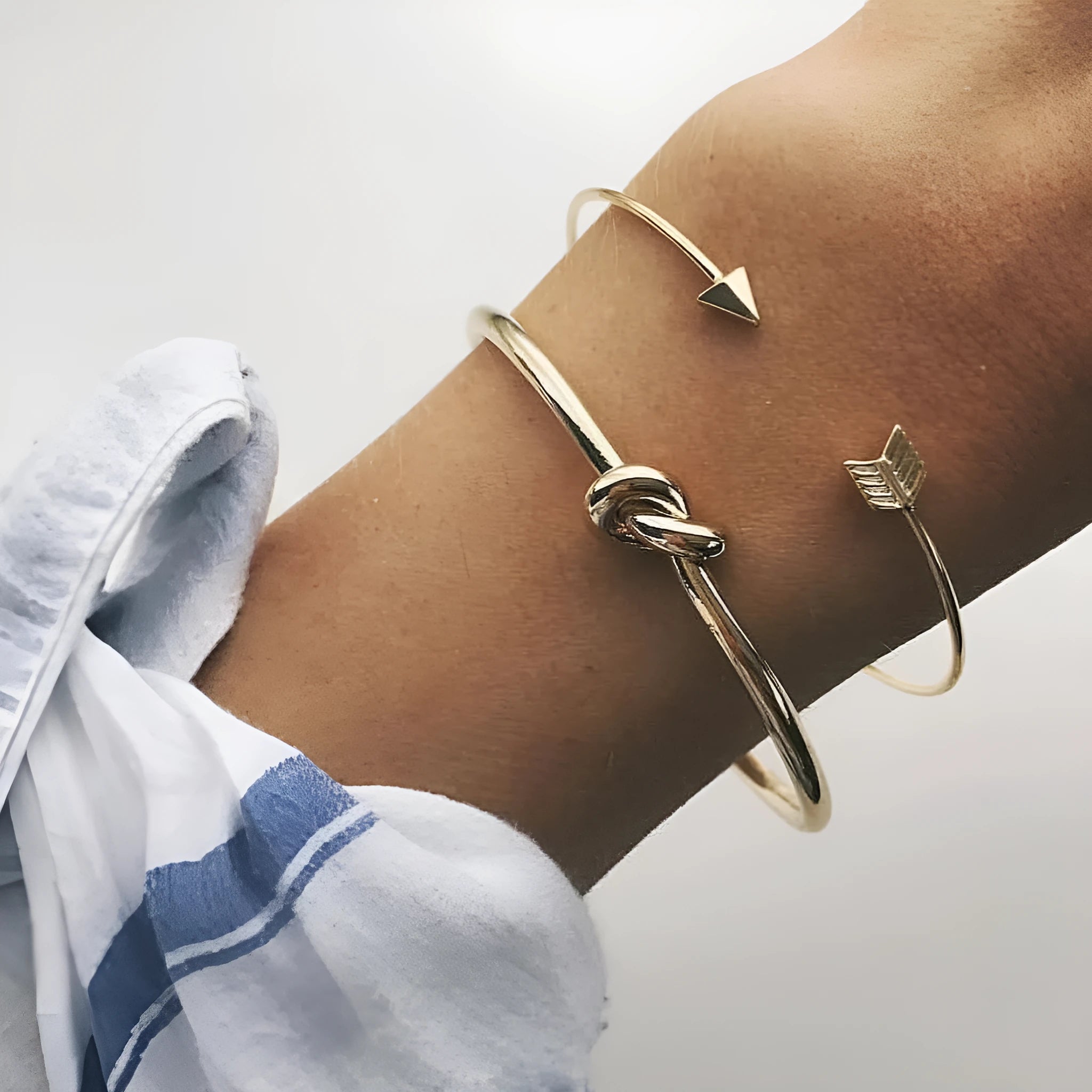 Gold electroplated women's vintage cuff bracelet with arrow knot detail