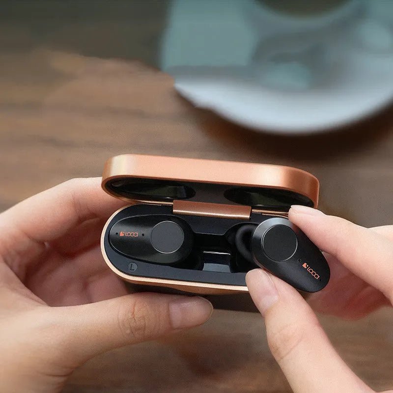 Black wireless Bluetooth headset with charging stand featuring active noise cancellation