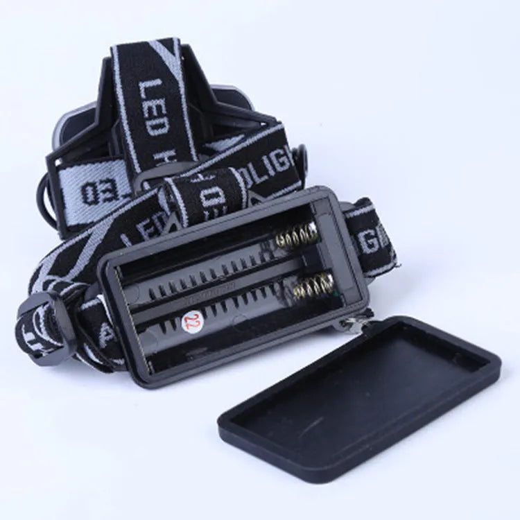 Outdoor head-mounted LED torch with adjustable strap, shown with strong beam illumination.
