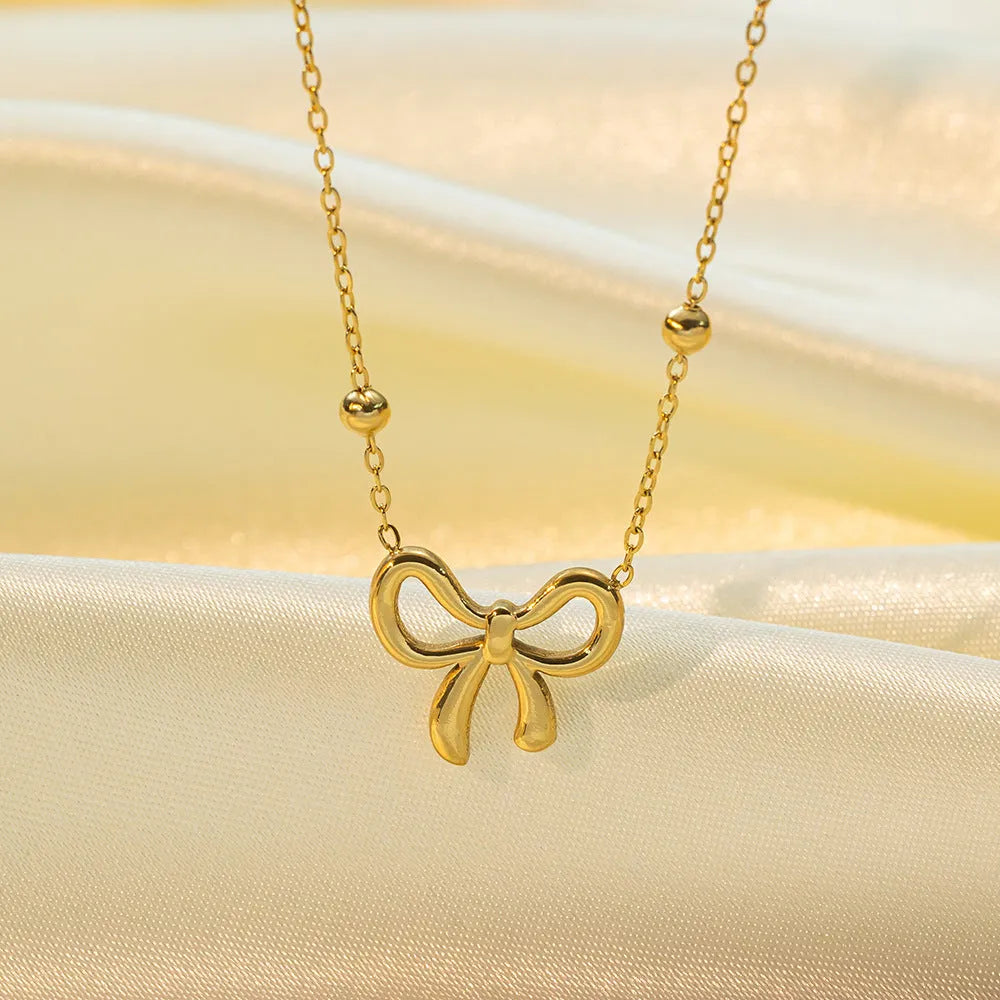 Gold electroplated bow necklace with titanium steel cross chain, adjustable 41-50cm length