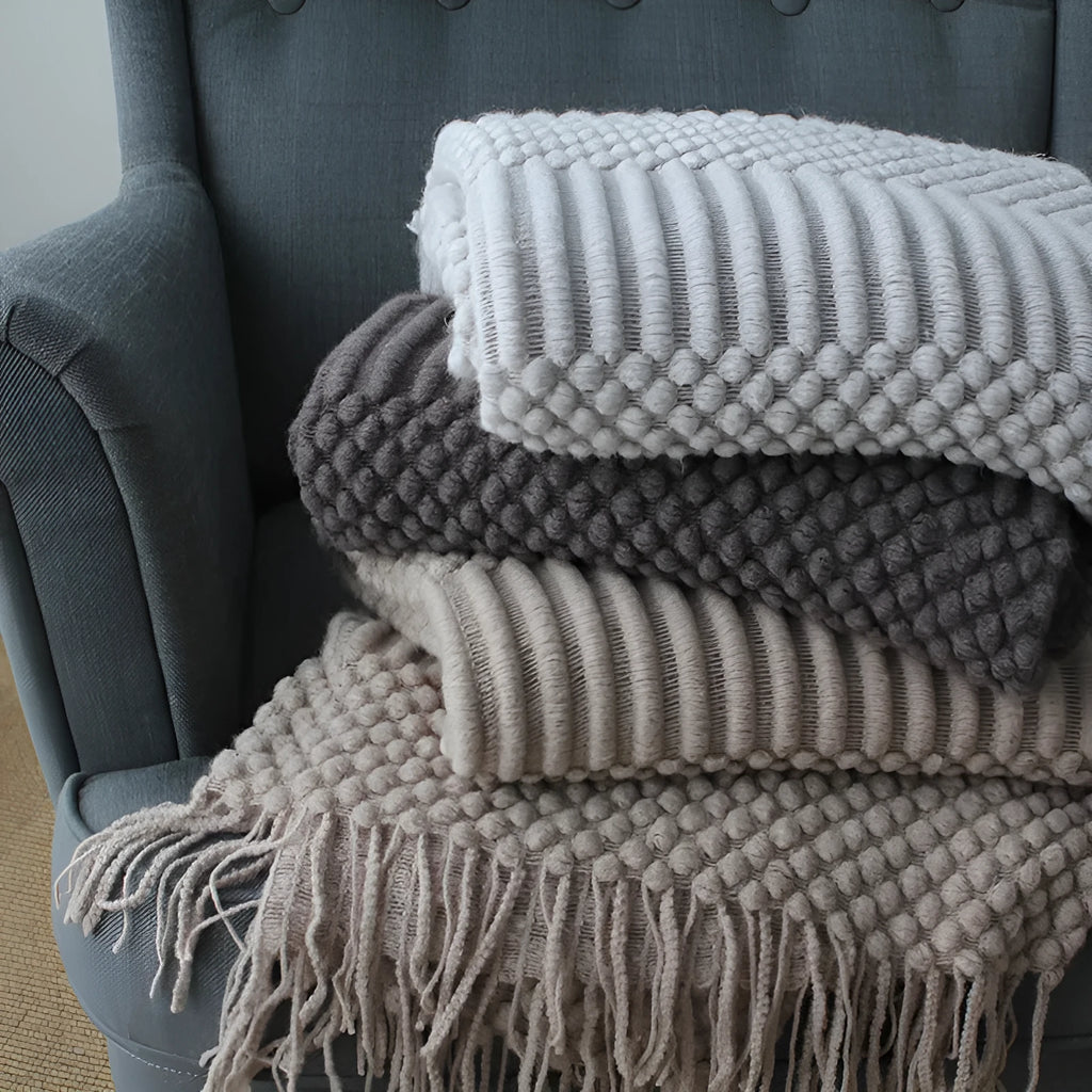 Small light grey polyester nap blanket folded, showing its size of 127 by 170 centimetres.