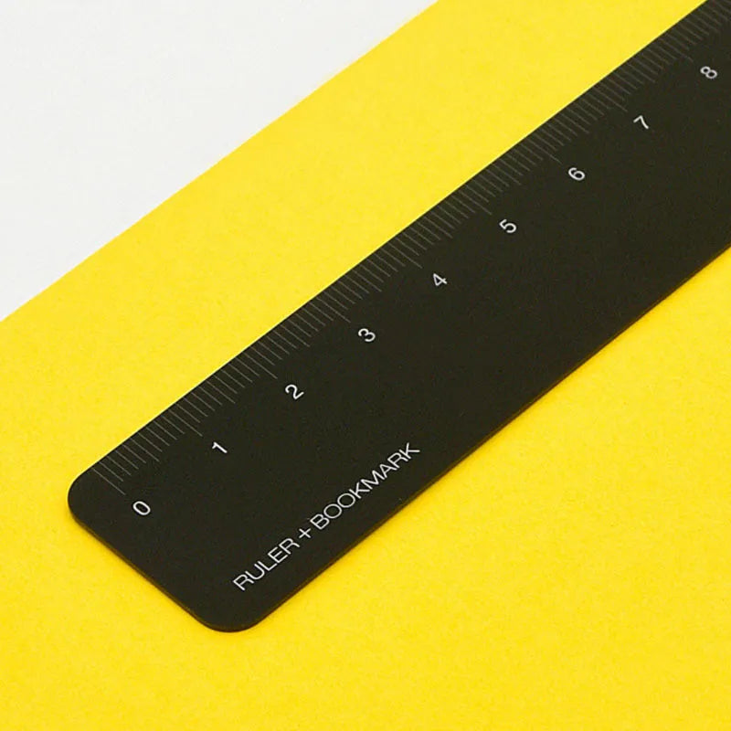 RUMA aluminium bookmark ruler showing 15cm laser-engraved scale in black finish