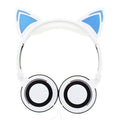 Colourful LED cat ear headphones with illuminated ears and cushions on a dark background.