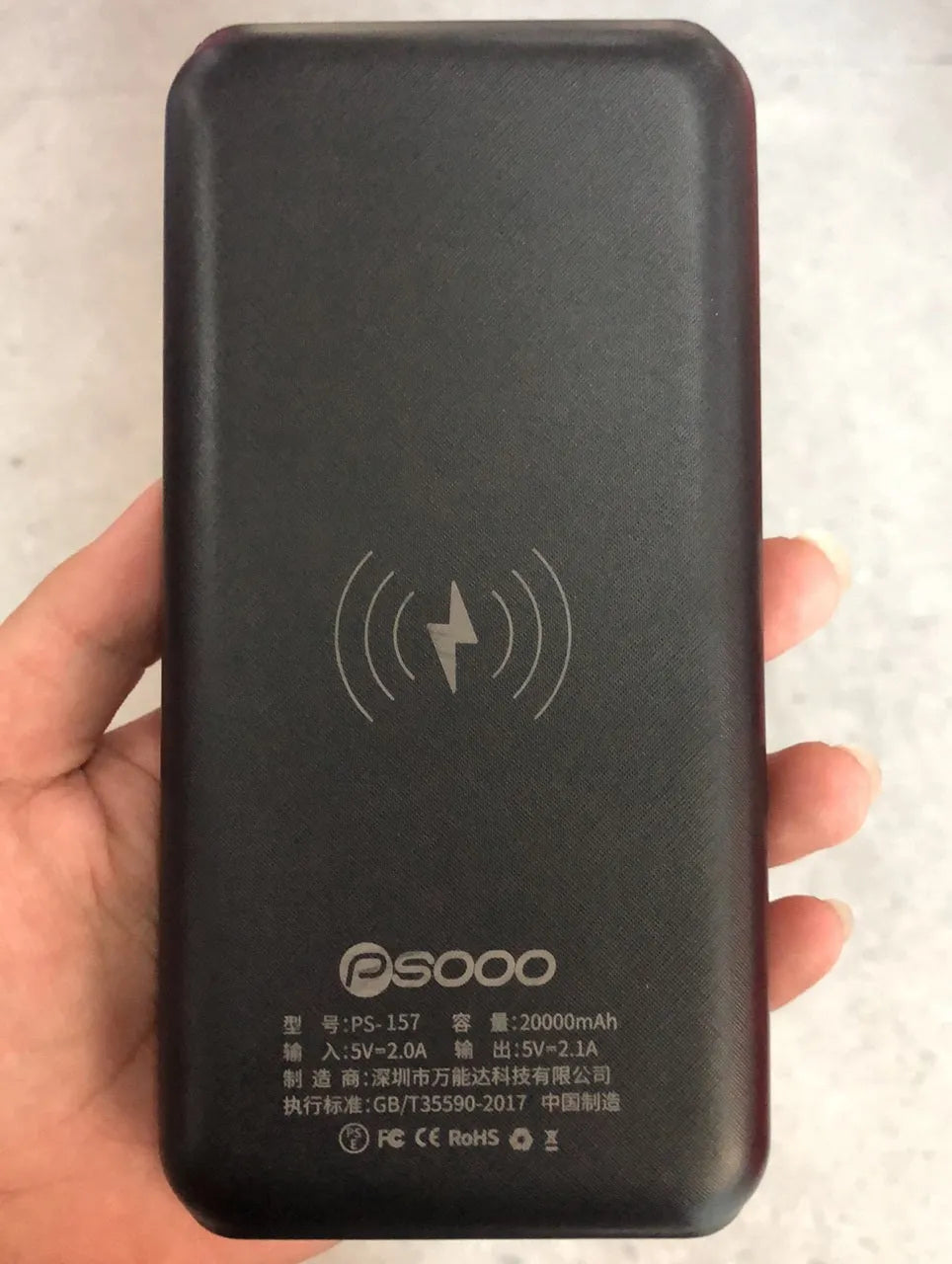 Portable power bank with wireless charging surface and USB ports in black colour
