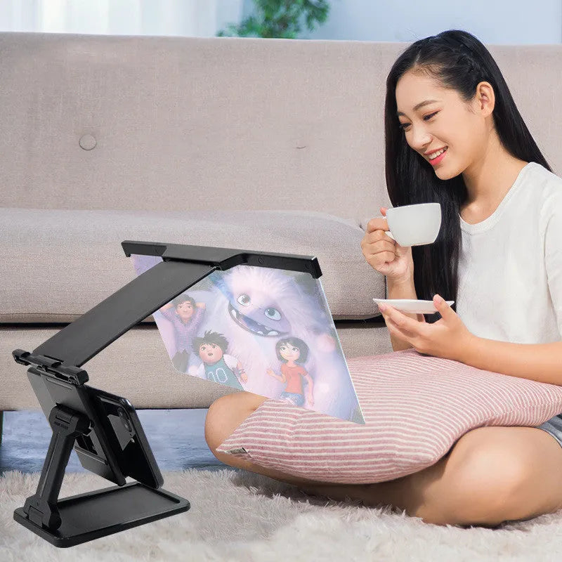 Black L20 split mobile phone screen magnifier with acrylic lens and ABS shell next to its adjustable phone bracket.