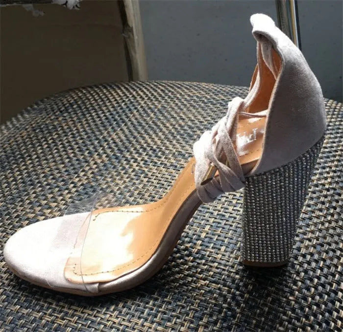 Black and Gold pointed toe plastic high heels for women, side view.