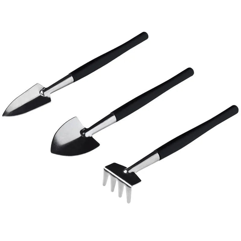 Black plastic and metal 16-piece mini gardening tool set for succulents and bonsai, laid out with a cushion.