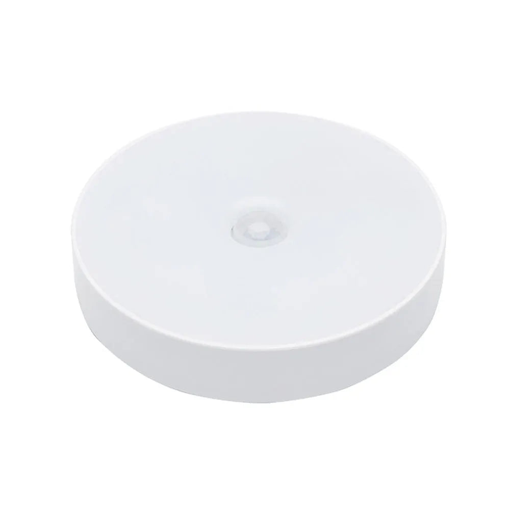 USB rechargeable motion sensor night light in beige or white, 86mm diameter, with adhesive tape