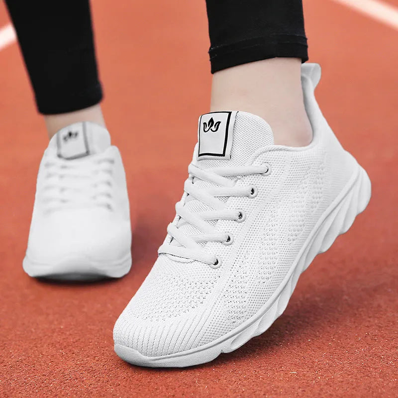 Women's white high-top casual sneakers with net-style upper, cross strap, and back lacing on a sticky rubber sole.