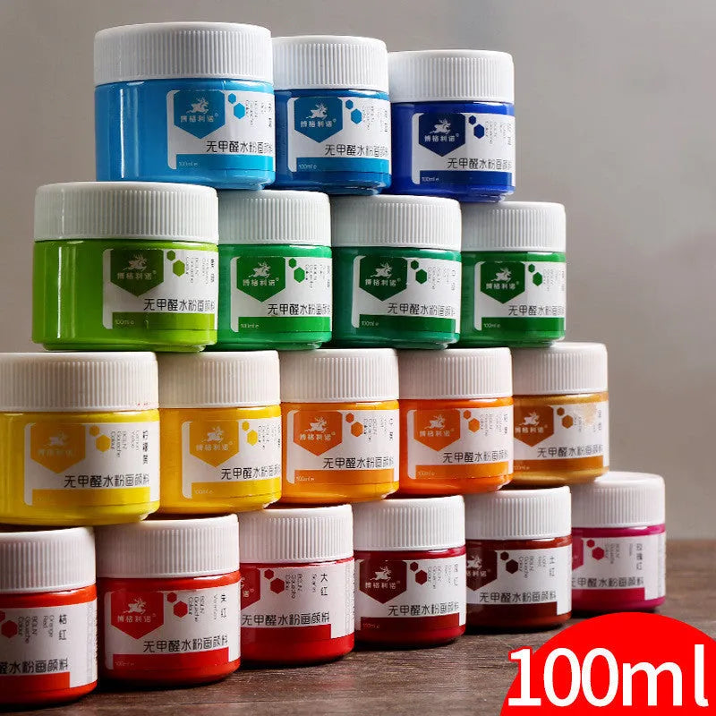 Bottles of beginner gouache paint in black, blue, red, yellow, orange, purple, sky blue, and dark blue.
