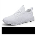 Men's black and white mesh sneaker with lace-up closure and round toe on a PVC sole.