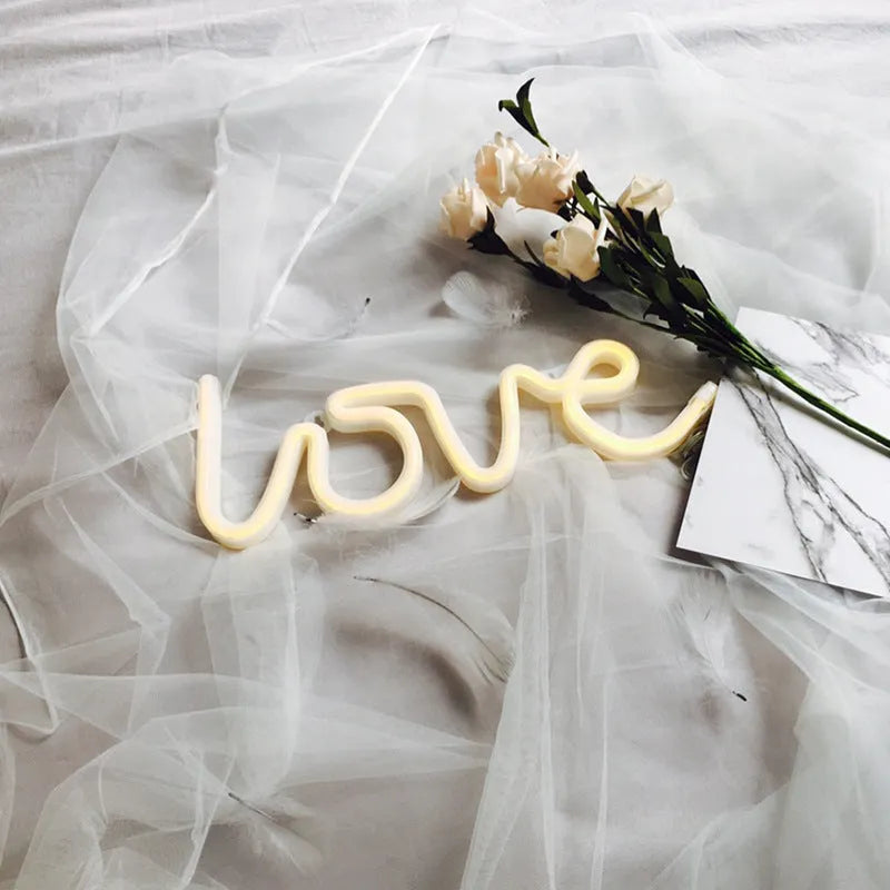 Pink and warm white LED neon love sign light for indoor wedding and party decorations.