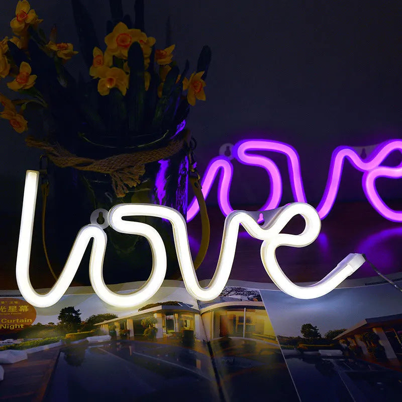 Pink and warm white LED neon love sign light for indoor wedding and party decorations.