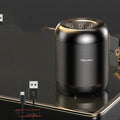 Compact black or white wireless Bluetooth speaker with card reader slot and USB port