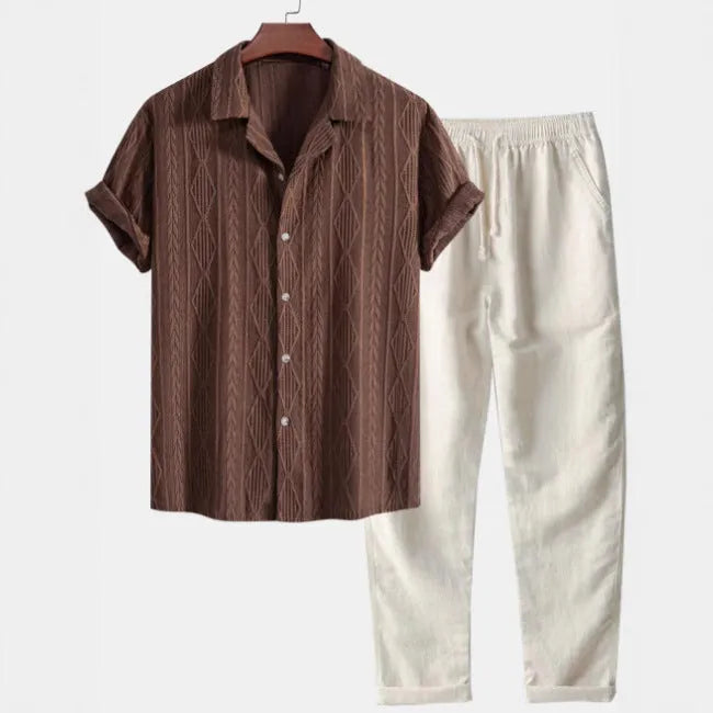 Men's slim fit camouflage print linen-style suit with short sleeve shirt and trousers on a hanger.