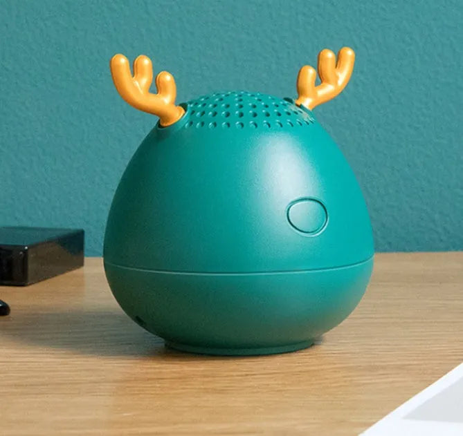 Compact portable Bluetooth speaker in white, pink, or green with USB charging cable