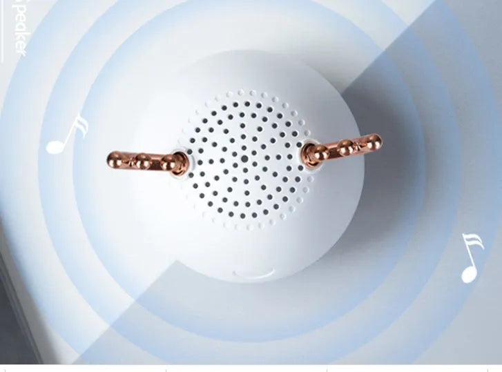 Compact portable Bluetooth speaker in white, pink, or green with USB charging cable