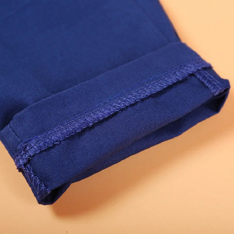 Blue boys' smart clothing set featuring a turtleneck, vest, trousers, and tie on a hanger