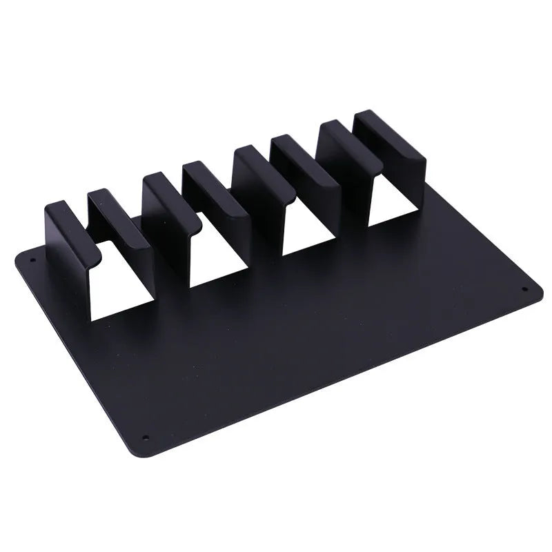 Black plastic clipper storage frame mounted on wall holding four electric hair clippers