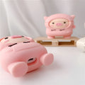 Pink silicone flip case with a cartoon pig design for AirPods and AirPods Pro, shown with a keychain hook.