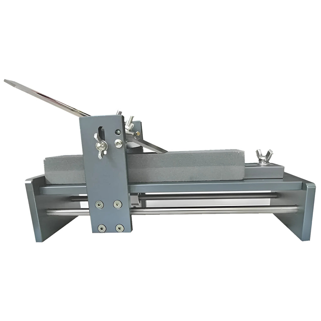 Aluminium fixed angle sharpening tool for woodworking chisels and planers on a workbench.