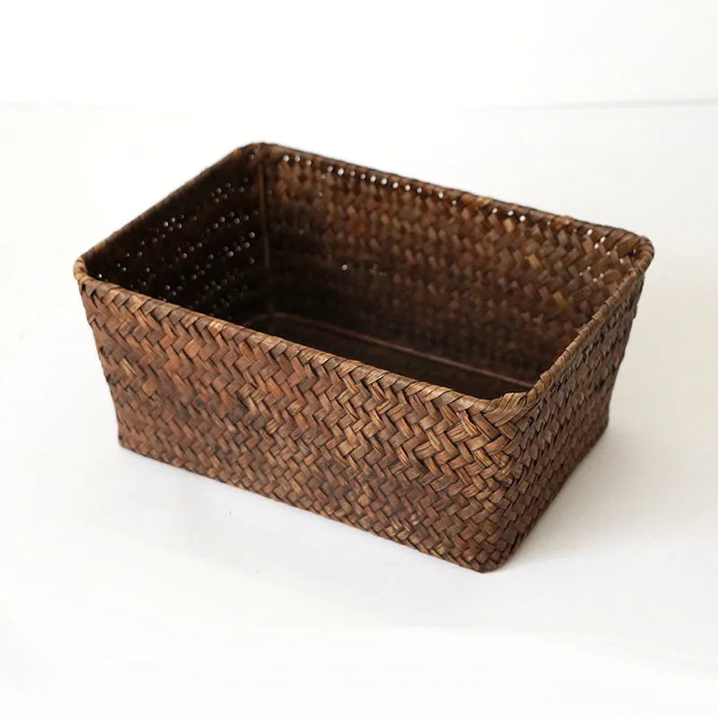 Woven straw desktop storage box in natural colours with pens and cosmetics inside