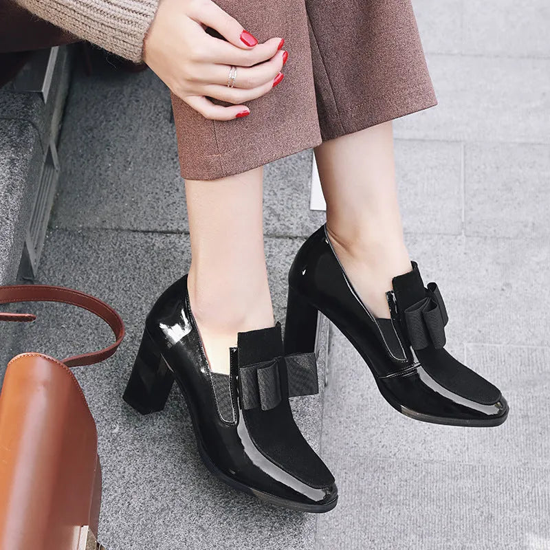 Large size black patent leather women's high heel shoe with a thick heel over 8cm.